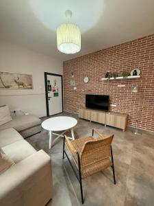 a living room with a couch and a table at Caesar Resort & SPA - Rahat & Konforlu Daireler in Iskele +103 photos