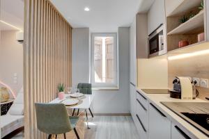 a kitchen and dining room with a table and chairs at Serenity Suite in Bourgoin