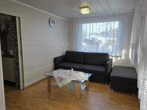 a living room with a couch and a table at Ferienhaus Alla, Neeberg/Usedom in Neeberg