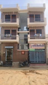 a motorcycle parked in front of a building at Kamal Kishori Dham in Barsāna