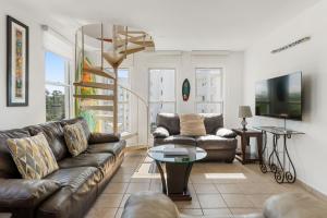 a living room with a couch and a table at Costa Ensenada Penthouse 505 across the street from Balneario beach in Rincon