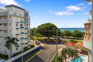 a view of the ocean from a building at Costa Ensenada Penthouse 505 across the street from Balneario beach in Rincon