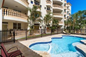 a swimming pool in front of a apartment building at Costa Ensenada Penthouse 505 across the street from Balneario beach in Rincon