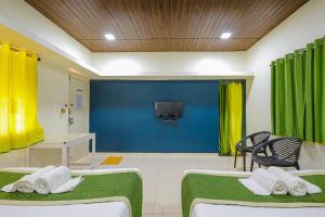a hospital room with two beds and a tv at Kokanwadi Resort in Ratnagiri