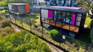 an overhead view of a tiny house with pink curtains at Crossfire @ Home in Somerset West