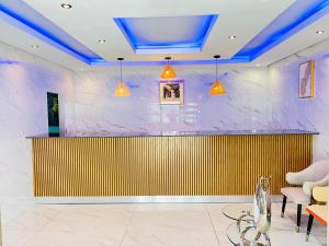 a lobby with a yellow and purple wall at Nakawa Guest Lodge in Brakpan