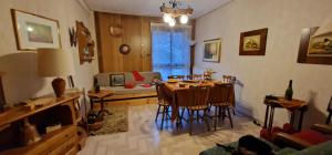 a living room with a table and chairs in it at Rifugio dei Pini in Roccaraso