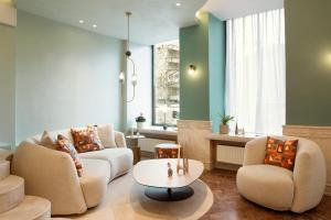 Una sala de estar con dos sofás y una mesa. en Zeus Essence Bucharest Venezia, en Bucarest