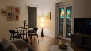 a living room with a couch and a table and a television at La Esquina in Denia