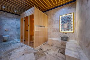 a bathroom with a shower and a sink and a toilet at Cappadocia Secret Hill Cave Suites in Goreme