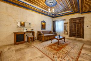 a living room with a couch and a table at Cappadocia Secret Hill Cave Suites in Goreme