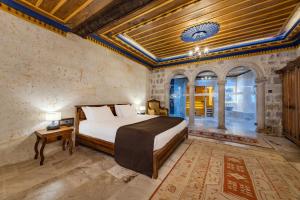 a bedroom with a bed in a room with a ceiling at Cappadocia Secret Hill Cave Suites in Goreme +191 photos