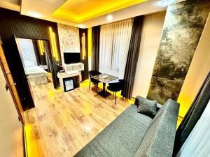 a living room with a couch and a table at Taksim Luxury Arcadia Hotel in Istanbul