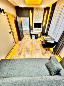 a living room with a bed and a desk and a computer at Taksim Luxury Arcadia Hotel in Istanbul