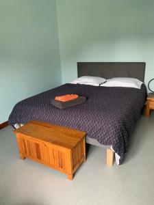 a bedroom with a bed with a wooden table at L'Arbre de Vie in Montmarault