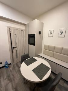 a white room with a table and a couch at Apartament for Guest in Jelgava