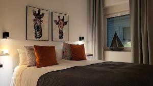a bedroom with a bed with two giraffe heads on the wall at La Esquina in Denia