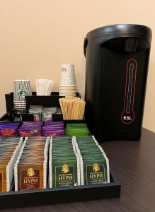 a tray filled with different types of food and a coffee pot at Americana By California in Yerevan