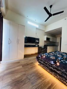 ein Schlafzimmer mit Bett und Deckenventilator in der Unterkunft Serenity suits in Sūrajpur