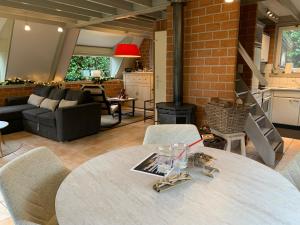 a dining room with a table and a living room at La Casita E41 in Lanaken