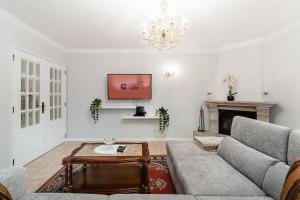 a living room with a couch and a fireplace at GuestReady - Urban rustic in Esposende in Esposende