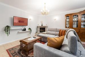 a living room with a couch and a table at GuestReady - Urban rustic in Esposende in Esposende