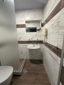a bathroom with a toilet and a sink at Brani Family Hotel in Ruse +31 photos