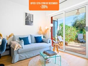 a living room with a couch and a glass table at Le Cocon - 5 min to Monaco - Ideal couple or business - Free private parking - Near events - Terrace and balcony - Premium services in Fontvieille