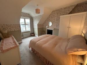 Un dormitorio con una cama grande y una chimenea. en Seaside apartment, en Bexhill-on-Sea