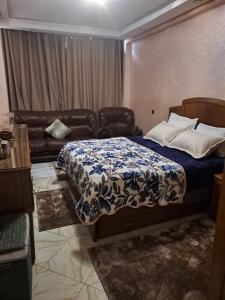 a bedroom with a bed and a couch at Haytam in Sale