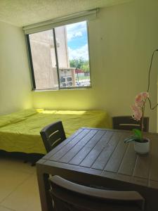 a dining room with a table and a window at APARTAMENTO RICAURTE Cund in Ricaurte