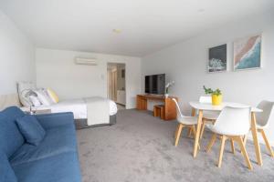 a hotel room with a bed and a table and chairs at Bay View Alfresco in Lorne