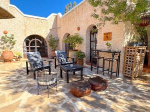 a patio with chairs and tables in front of a building at Palais Tiyana in Al Ghar