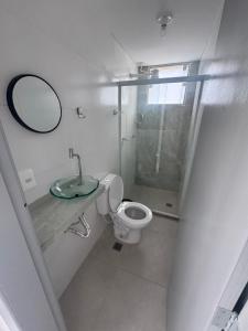 a bathroom with a shower and a toilet and a mirror at Família Ebeneze in Nova Friburgo
