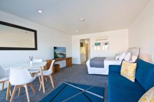 a hotel room with a bed and a table and chairs at Bay View Ocean Views in Lorne