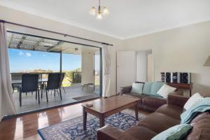 a living room with a couch and a table at Island View in Hayborough