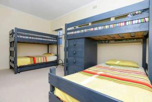 two bunk beds in a room with two beds at Island View in Hayborough