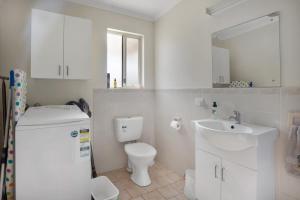 a white bathroom with a sink and a toilet at Island View in Hayborough +11 photos