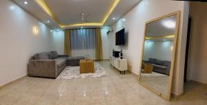 a living room with a couch and a mirror at Nyali 3 Bedroom Apartment Skyview in Mombasa