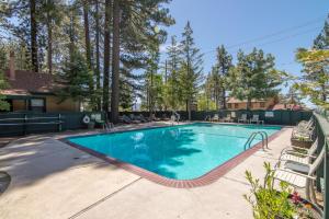a swimming pool in a yard with chairs at Lakeside Condo Close to Slopes Excellent Location in Tahoe Vista