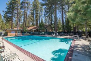 a large swimming pool with chairs and a house at Lakeside Condo Close to Slopes Excellent Location in Tahoe Vista +42 photos