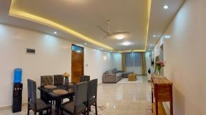 a dining room and living room with a table and chairs at Nyali 3 Bedroom Apartment Skyview in Mombasa