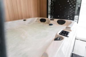 a bath tub filled with water in a bathroom at Lynx spa detente Orford in Magog-Orford +14 photos