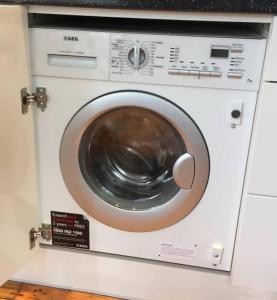 a white washing machine sitting in a kitchen at Modern Studio, 1st floor, King Street Views in Nottingham