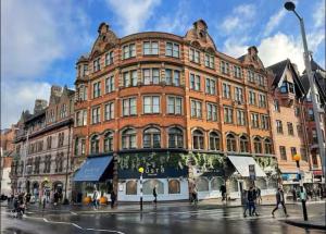 a large red brick building on a city street at Modern Studio, 1st floor, King Street Views in Nottingham