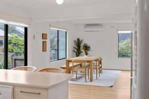 a kitchen and dining room with a table and chairs at Saltwater Shack in Anglesea