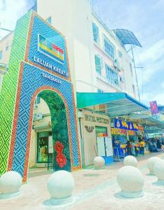 a building with an arch in the middle of a street at Hotel Western in Sandakan