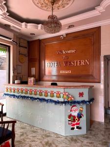 a welcome to hotel western sign in a lobby at Hotel Western in Sandakan