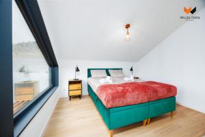 En eller flere senge i et værelse på Wilcza Osada Resort