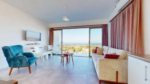 a living room with a couch and a view of the ocean at Villa Cypress Villas in Kyrenia